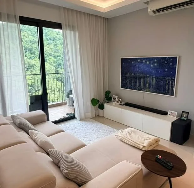 Living features: beige fabric L-shape sectional sofa, white area rug, wall-mounted TV, white TV console, decorative plant in ceramic pot, framed artwork on wall, floor-to-ceiling sliding glass door, sheer curtains, recessed ceiling lights, air conditioning unit, wooden coffee table; style: modern; view: garden.