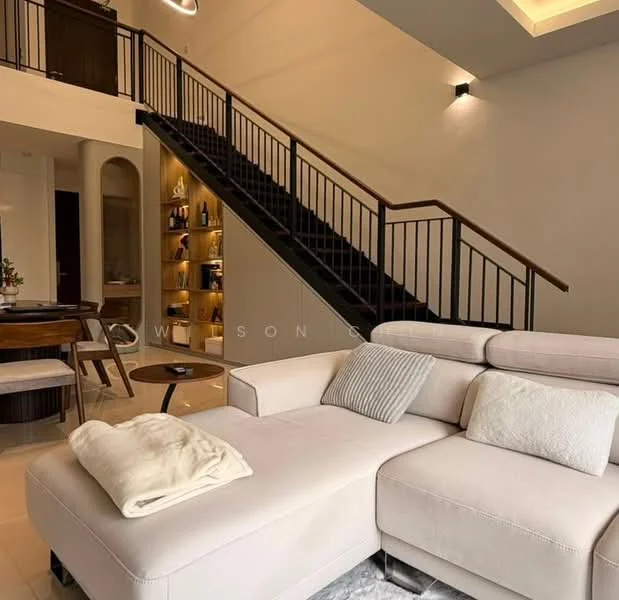 Living features: L-shape sectional sofa in light beige, decorative throw blanket on sofa, coffee table, area rug, recessed ceiling lights, wall-mounted lighting, staircase with black metal railing, built-in shelving unit with decorative items, dining area visible in background, large windows allowing natural light; style: modern.