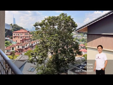 Room features: balcony view of city skyline, greenery from nearby trees, surrounding residential area, partially visible rooftops, clear blue sky, sunlight casting shadows, railings on balcony, urban landscape; view: city.