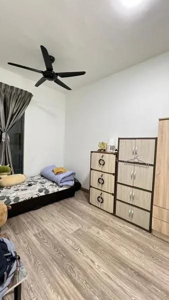 Bedroom features: queen-size bed, bedding with blue and yellow accents, black fabric headboard, 3-drawer chest of drawers in light wood, 2-door wardrobe in light wood, floor-to-ceiling window, grey curtains, 5-blade ceiling fan with light, laminate wood flooring, decorative plant on dresser; style: modern.