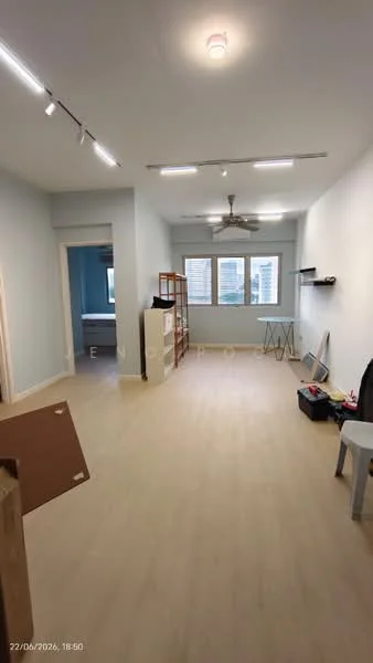Room features: light wood flooring, blue painted walls, recessed LED downlights, 5-blade ceiling fan, large windows with city view, open layout, shelving unit, wall-mounted shelf, decorative wall panel, storage boxes, folding chair; style: modern; view: city.