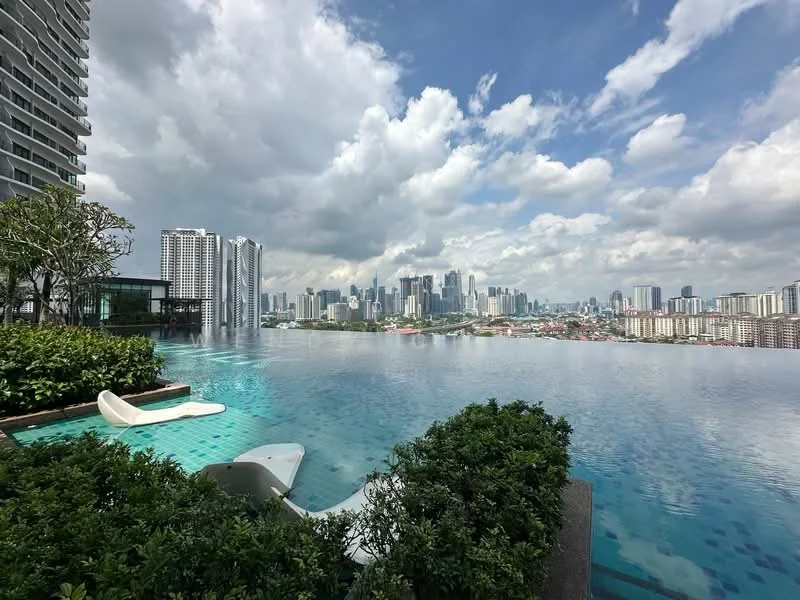 Exterior type: high-rise condominium; features: infinity pool, pool deck with loungers, landscaped garden with shrubs, city skyline view, surrounded by high-rise buildings, manicured greenery; style: modern.