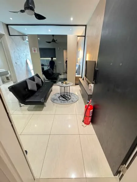 Living features: black leather sofa bed, round coffee table with metal base, wall-mounted TV, light-colored wall with texture, white tiled flooring, recessed ceiling lights, 5-blade ceiling fan, decorative wall mirror, fire extinguisher, open layout to adjacent room; style: modern.