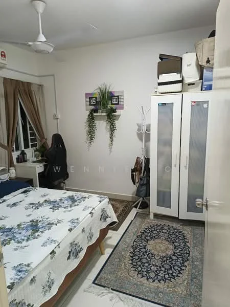 Bedroom features: queen-size bed with floral bedding, wooden bedside table, black office chair, white wardrobe with sliding doors, decorative area rug with geometric pattern, ceiling fan, curtains on window, wall-mounted artwork, potted plant, light-colored walls, laminate flooring; style: modern.