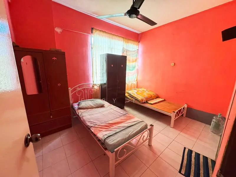 Bedroom features: red painted walls, white tiled flooring, single bed with mattress, wooden wardrobe, wooden bed frame, ceiling fan, window with sheer curtains, area rug with striped pattern.