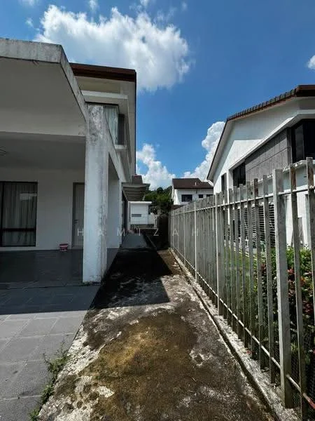 Exterior type: semi-detached house; features: two-storey structure, concrete facade, sloped roof, fenced perimeter, paved walkway, landscaped garden area, visible drainage, windows with glass panes, outdoor space beside the house; style: modern.