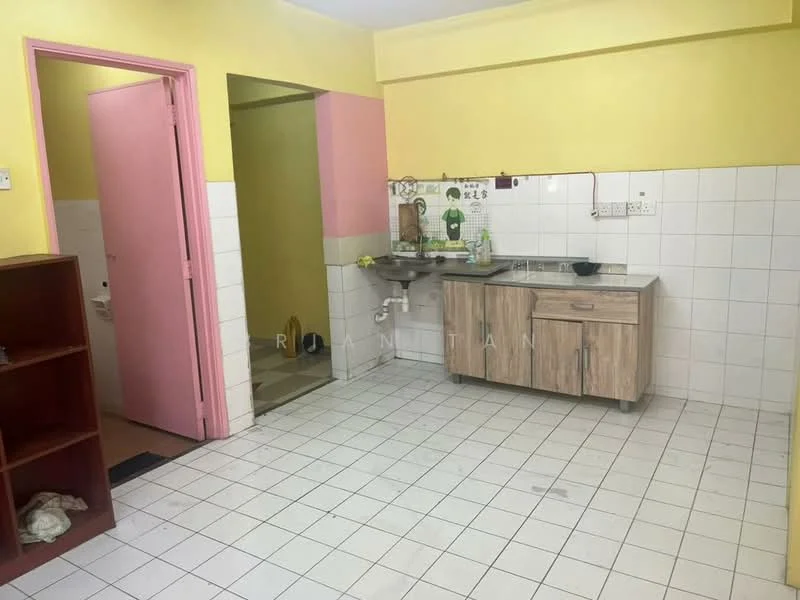 Kitchen features: yellow painted walls, white tiled flooring, wooden cabinetry with light wood finish, stainless-steel sink, wall-mounted faucet, countertop with space for appliances, open shelving, doorway leading to another room, pink door, wall tiles up to countertop level.