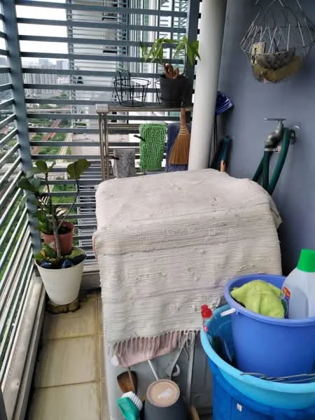 Balcony features: sliding glass door, metal railing, ceramic tile flooring, potted plants, cleaning supplies, broom, storage box covered with fabric, hanging planter, green cleaning cloth, water hose, shelf with gardening tools; view: city.