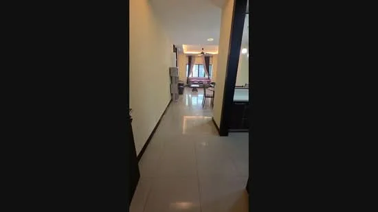 Room features: white painted walls, glossy ceramic tile flooring, recessed downlights, large windows with sheer curtains, open layout, neutral color scheme, doorway leading to another room, visible furniture in the background; style: modern.