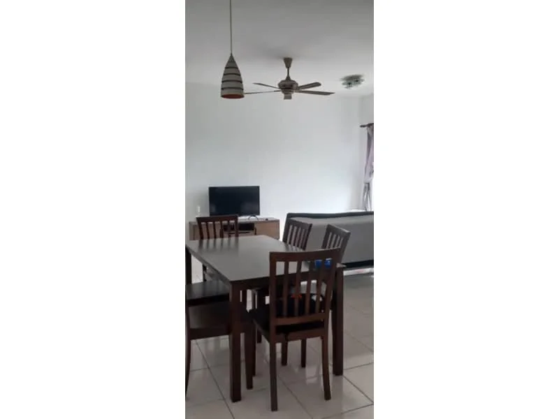 Dining features: dining table with four chairs, ceiling fan, wall-mounted TV, light fixture with pendant lamp, white painted walls, tile flooring, sofa in background, curtains on window; style: modern.