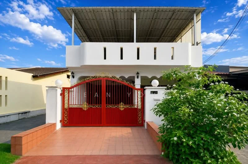 Exterior type: detached bungalow; features: red wrought iron gate, white painted facade, flat roof, covered porch area, manicured lawn, paved walkway, decorative wall lights, surrounded by greenery; style: modern.