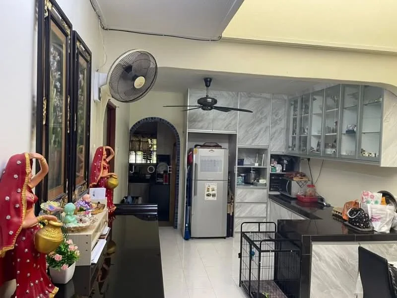 Kitchen features: white tiled flooring, grey marble countertop, stainless-steel fridge, built-in kitchen cabinets with glass fronts, black kitchen island, 5-blade ceiling fan, wall-mounted microwave, sink with faucet, decorative figurines, open shelving, kitchen appliances, recessed lighting; style: modern.