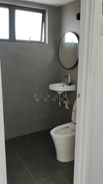 Bathroom features: grey tiled walls, dark grey floor tiles, round mirror, wall-mounted sink, chrome faucet, one-piece toilet, window for natural light, soap dispenser, toothbrush holder; style: modern.