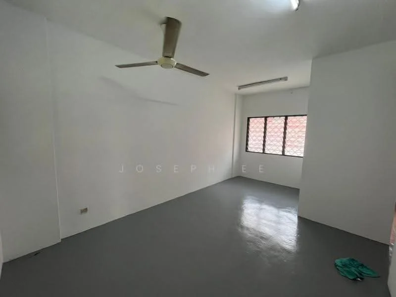 Room features: white painted walls, grey flooring, ceiling fan, single window with grille, light fixture on ceiling.