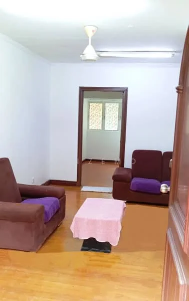 Living features: brown fabric sofa, purple throw blanket on sofa, wooden coffee table with white tablecloth, laminate flooring, ceiling fan, white painted walls, doorway leading to another room. Room features: two windows with patterned curtains, wooden door frame, light fixture on ceiling.