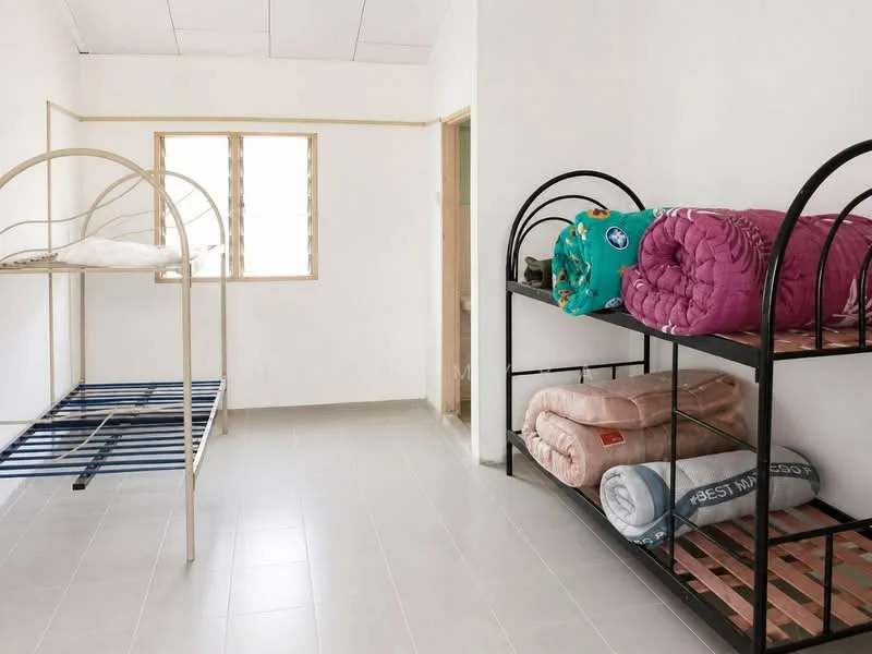 Bedroom features: bunk beds with metal frame, single mattress on top bunk, single mattress on bottom bunk, light-colored walls, white ceiling, tile flooring, window with wooden frame, unmade bedding, blankets in various colors; style: minimalist.