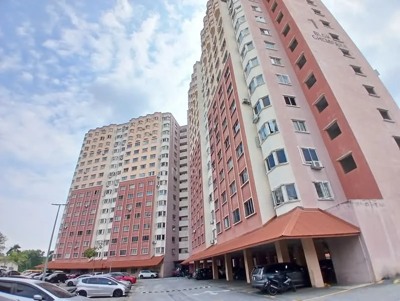 Exterior type: mid-rise condominium; features: pink painted facade, glass windows, covered parking area, multiple storeys, balconies on upper floors, awning at entrance, surrounded by greenery, open-air parking lot; style: modern.