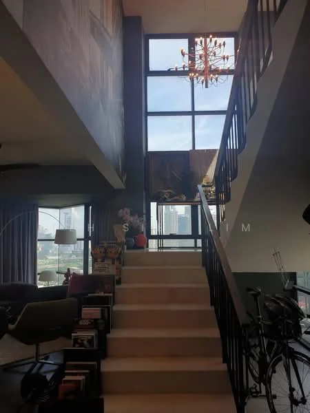 Room features: staircase with black metal railing, large floor-to-ceiling windows, chandelier with multiple bulbs, decorative wall art, laminate flooring, open space layout, city skyline view, potted plants, seating area with armchair, bookshelves, natural light from windows; style: modern; view: city.