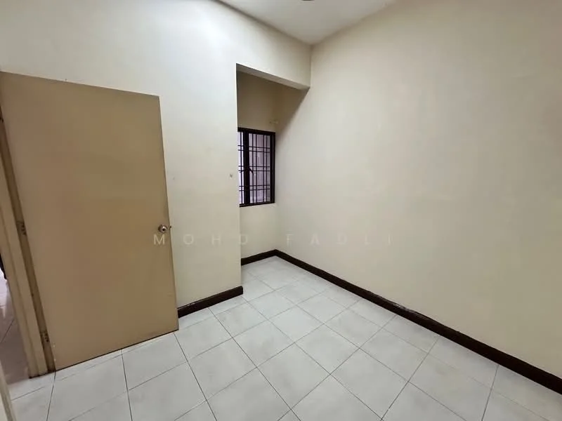 Room features: cream painted walls, white tiled flooring, single wooden door, small window with grid, dark wood skirting.