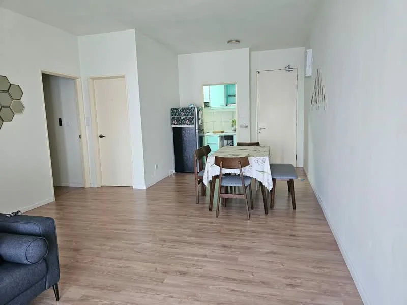 Living features: light wood laminate flooring, white painted walls, sofa in grey, dining table with 4 wooden chairs, fridge, door leading to kitchen, door leading to hallway, decorative wall art; style: modern. Kitchen features: green cabinetry, countertop, stainless-steel sink, built-in oven, stove, tile backsplash; style: modern.
