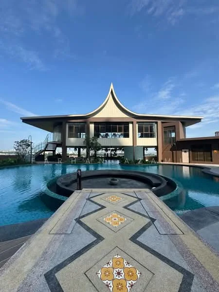 Exterior type: clubhouse; features: modern architectural design with a distinctive roof shape, large glass windows, surrounding infinity pool, decorative stone pathway leading to the entrance, landscaped greenery around the pool area, outdoor seating area, pool deck with loungers, water feature in front of the building; style: modern.