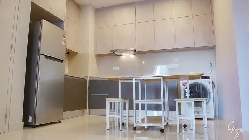 Kitchen features: stainless-steel fridge, built-in cabinetry with light wood finish, grey lower cabinetry, white countertop, stainless-steel range hood, wall-mounted lighting, white washing machine, 4-seat dining table with wooden top, white stools, glossy tile flooring, neutral wall color, open layout; style: modern.