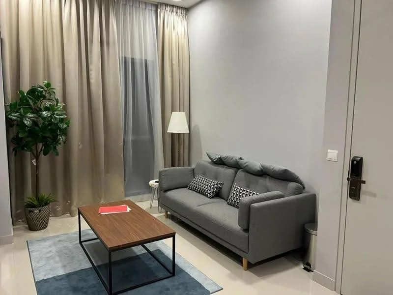 Living features: grey fabric sofa, wood coffee table, area rug in light blue, floor lamp, potted plant, curtains in beige, white walls, light-colored flooring; style: modern.