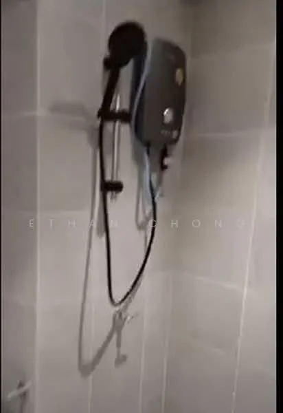 Bathroom features: shower with handheld showerhead, wall-mounted water heater, grey tiled walls, white grout, chrome shower valve, glass shower enclosure, non-slip floor tiles; style: modern.
