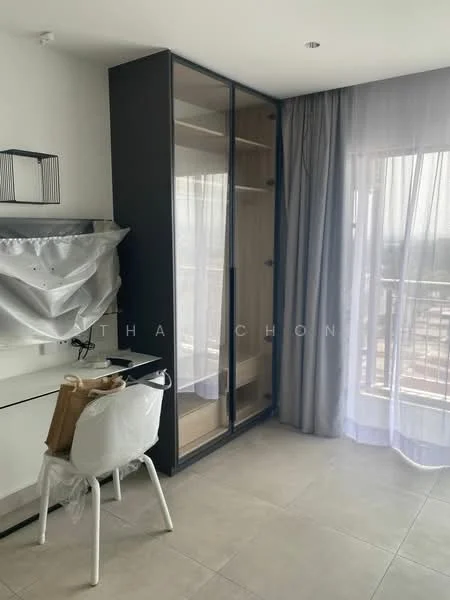 Room features: floor-to-ceiling windows, curtains, built-in wardrobe with glass doors, white desk, white chair, light-colored tile flooring, neutral wall color, balcony access; style: modern; view: city.