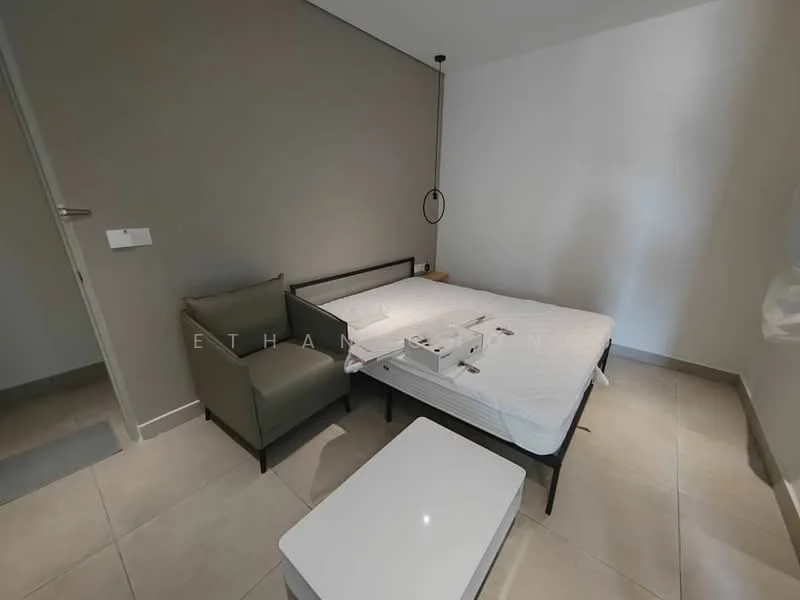 Bedroom features: queen-size bed frame, mattress on bed frame, grey accent wall, white painted walls, tile flooring, small coffee table, single armchair in grey fabric, wall-mounted light fixture, floor-to-ceiling window, curtains, minimalist decor; style: modern.