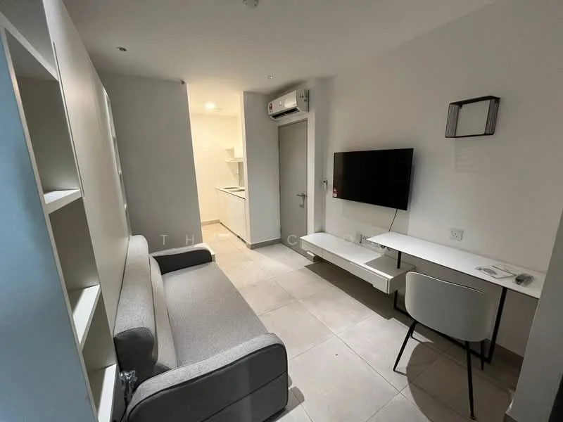 Living features: grey fabric sofa, wall-mounted TV, white TV console, white wall-mounted shelf, tile flooring, 1 wall-mounted split AC, recessed downlights, neutral painted walls, small dining table with chair; style: modern. Kitchen features: white cabinetry, countertop with sink, kitchen appliances visible, tile flooring; style: modern.