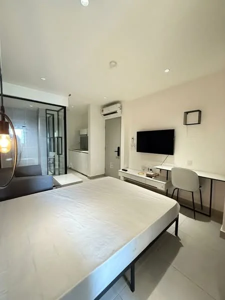 Bedroom features: queen-size bed frame without mattress, wall-mounted TV, study desk with chair, air conditioning unit, recessed downlights, floor-to-ceiling glass partition, grey sofa, light-colored wall, tile flooring; style: modern.