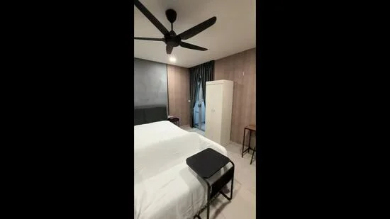 Bedroom features: queen-size bed with white bedding, black ceiling fan, grey accent wall, white wardrobe, wooden side table, floor-to-ceiling window with black curtains, tile flooring, recessed lighting; style: modern.