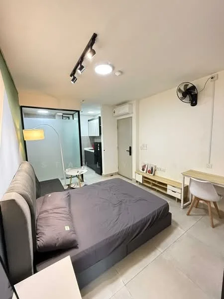 Bedroom features: queen-size bed with grey bedding, wall-mounted ceiling light, 5-blade ceiling fan, white painted walls, grey tiled flooring, study desk with chair, small side table, glass partition to bathroom, built-in wardrobe, door to hallway; style: modern.
