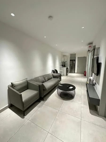 Living features: grey fabric 3-seater sofa, grey fabric armchair, black round coffee table, wall-mounted TV, TV console, recessed downlights, white painted walls, tile flooring, open layout, kitchen area visible in background, fridge visible in background, doorway leading to other rooms; style: modern.