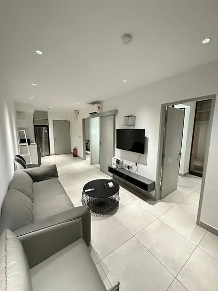 Living features: grey leather sofa, black coffee table, wall-mounted TV, TV console, recessed downlights, cream tiled flooring, white painted walls, open layout, sliding glass door, fire extinguisher visible, kitchenette area visible in background, doorway leading to bedroom, doorway leading to bathroom; style: modern.