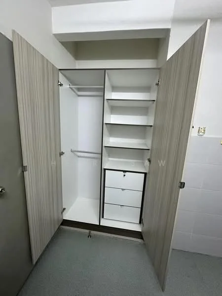 Room features: built-in wardrobe, white shelves, wooden cabinet doors, drawer unit, hanging rod, light grey flooring, white walls, neutral color scheme; style: modern.