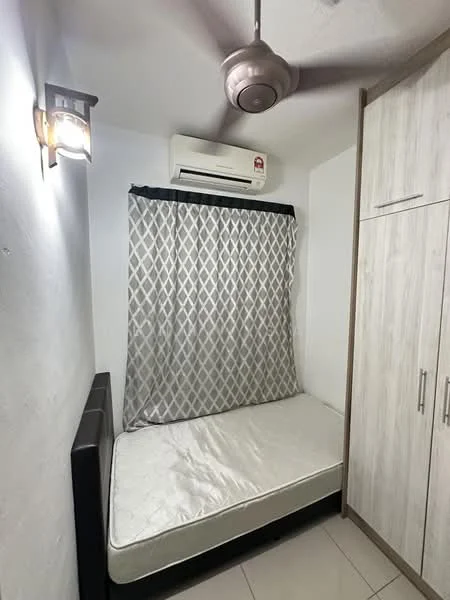 Bedroom features: single bed frame, mattress, ceiling fan, wall-mounted light fixture, air conditioning unit, grey patterned curtain, built-in wardrobe with sliding doors, white painted walls, tile flooring.