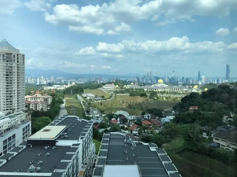 Exterior type: high-rise condominium; features: city skyline view, surrounded by greenery, manicured lawns, adjacent to residential area, multi-storey buildings, distant mountains, blue sky with clouds; style: modern.