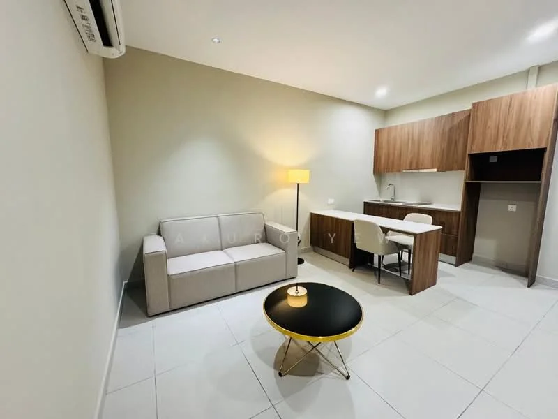 Living features: grey fabric sofa, round black coffee table with gold legs, wooden dining table with two chairs, kitchenette with wooden cabinetry, stainless-steel sink, built-in countertop, wall-mounted air conditioning unit, recessed ceiling lights, white tiled flooring, neutral painted walls; style: modern.