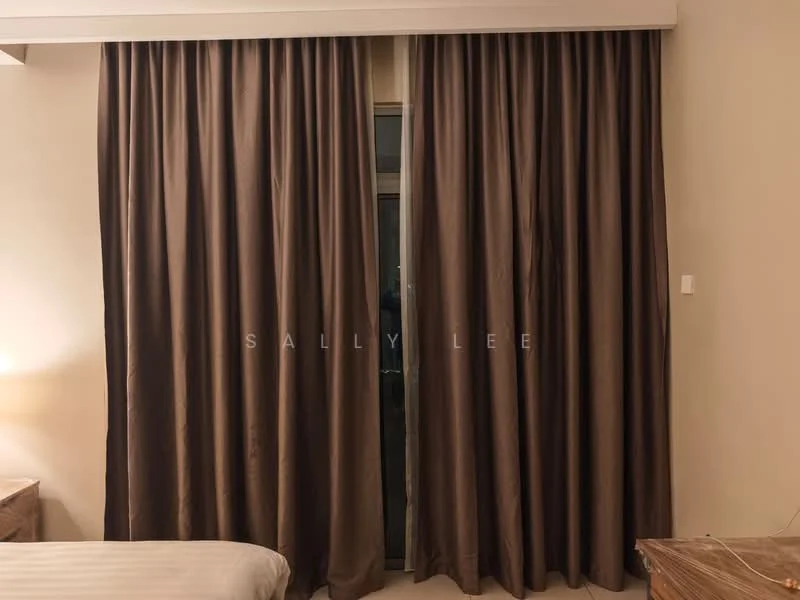Room features: brown curtains, floor-to-ceiling windows, wooden bedside table, bed with white bedding.