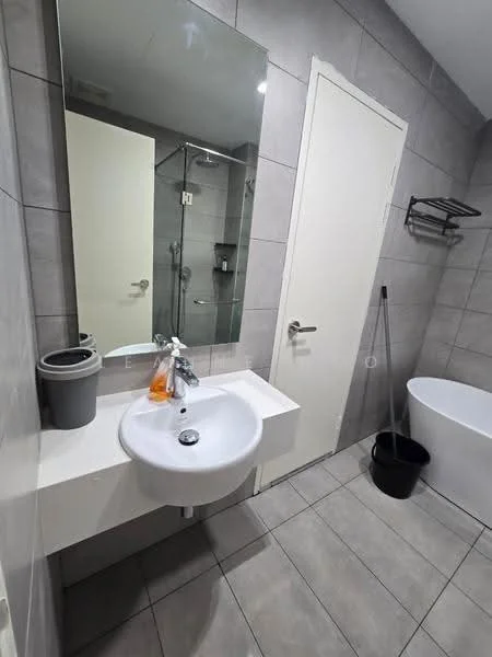 Bathroom features: single-bowl white sink, chrome basin mixer faucet, large wall-mounted mirror, grey tiled walls, light grey floor tiles, freestanding bathtub, glass shower enclosure, shower head, towel rack, waste bin, cleaning tool, white door; style: modern.