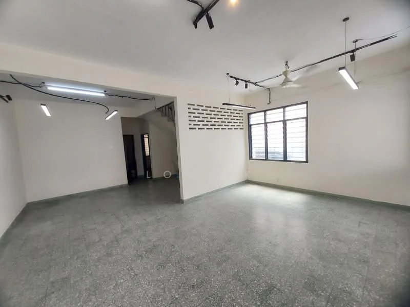 Room features: grey terrazzo flooring, white painted walls, exposed ceiling with track lighting, ceiling fan, large windows providing natural light, open layout, staircase visible in background, brick feature wall; style: modern.