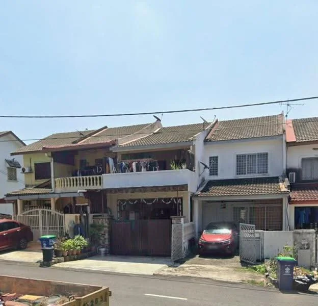 Exterior type: linked terrace house; features: two-storey house, red brick facade, flat roof, balconies on upper floor, front porch with gate, driveway with car, manicured lawn, laundry hanging on balcony, surrounded by residential street, visible parking area; style: modern.