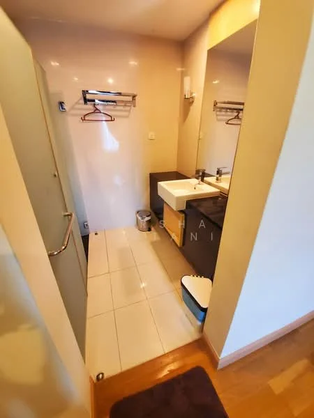 Bathroom features: glass shower enclosure, single-sink vanity with dark wood cabinet, white countertop, mirror above sink, chrome faucet, tiled flooring, towel rack, toilet, waste bin, hanging hooks, light fixture, neutral wall color; style: modern.