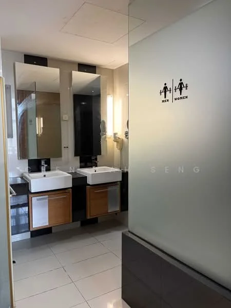 Bathroom features: double-sink vanity with wood cabinet, chrome basin mixer faucets, framed mirrors above sinks, tile flooring, wall-mounted lighting, glass partition, white walls, black accent wall, toilet signage for men and women; style: modern.