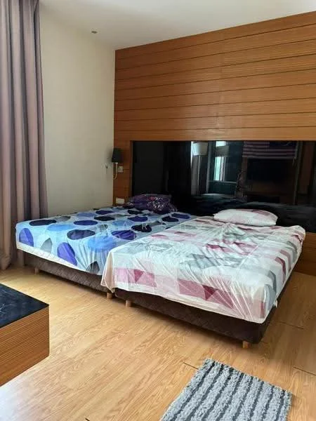 Bedroom features: two single beds with patterned bedding, wood panel accent wall, large window with sheer curtains, laminate flooring, wall-mounted reading lights, decorative area rug, built-in wardrobe, minimalist decor; style: modern.