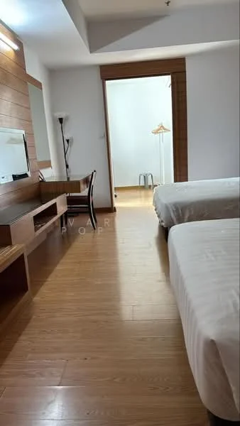 Bedroom features: two single beds with white bedding, wooden flooring, wooden accent wall, large mirror on wall, desk with chair, lamp, wardrobe with hanging space, window with natural light; style: modern.