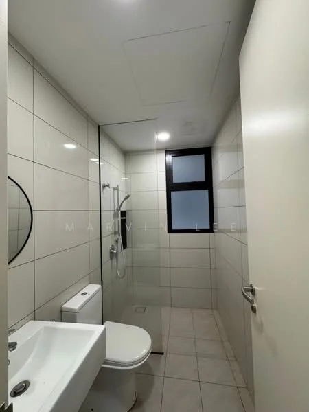 Bathroom features: white tiled walls, grey tiled flooring, glass shower enclosure, rain shower head, handheld shower, round mirror, single-sink vanity with white cabinet, one-piece toilet, wall-mounted faucet, window for natural light; style: modern.