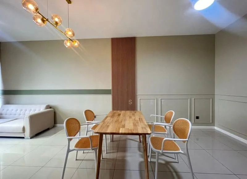 Dining features: wooden dining table, 4 white dining chairs with rattan seats, cream-colored walls, green accent wall, tile flooring, chandelier with multiple bulbs, decorative wall paneling, natural light from window; style: modern. Living features: white leather sofa, neutral wall color, tile flooring; style: modern.